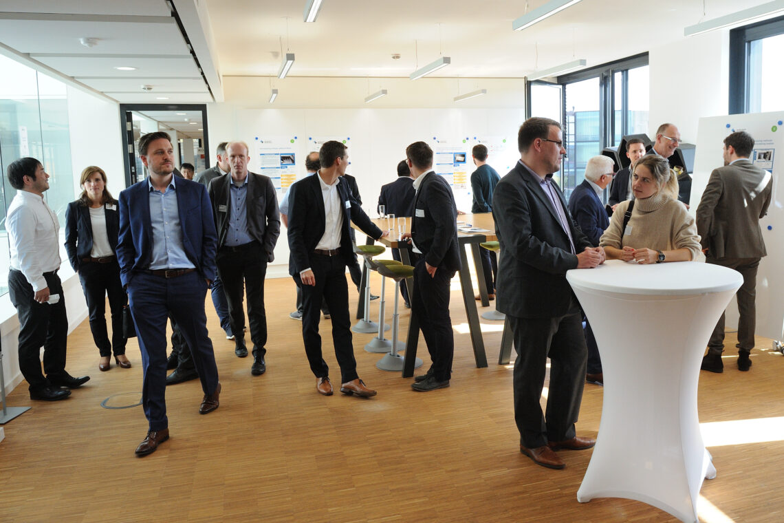 ACAM members are standing at tables and networking during a break of the annual meeting